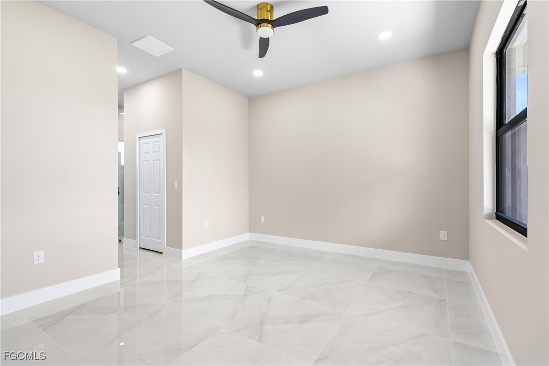 2809 25th Street Southwest Lehigh Acres, FL 33976 - Photo 19 of 36 an empty room with ceiling fan and window