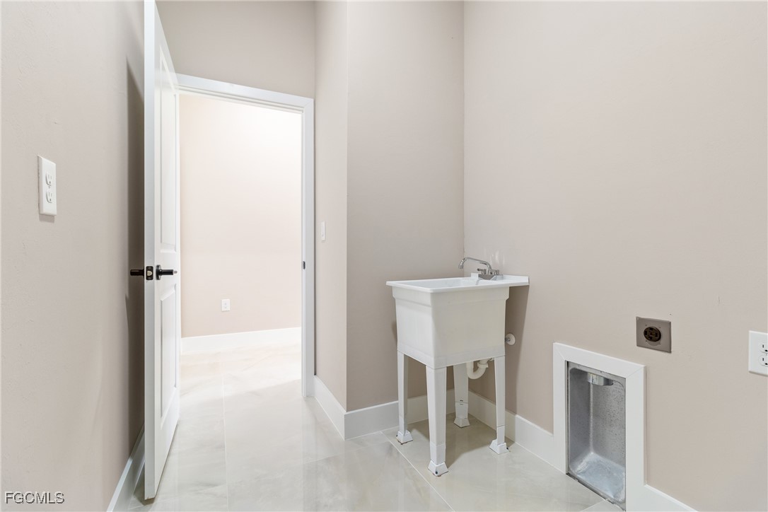 2809 25th Street Southwest Lehigh Acres, FL 33976 - Photo 20 of 36 a bathroom with a sink and a mirror