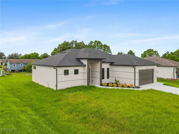 a front view of house with yard and garage