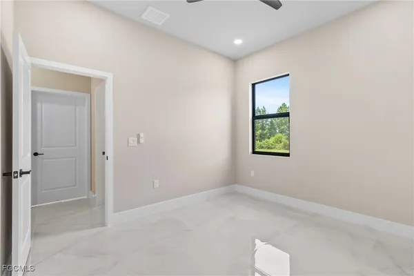an empty room with windows and closet