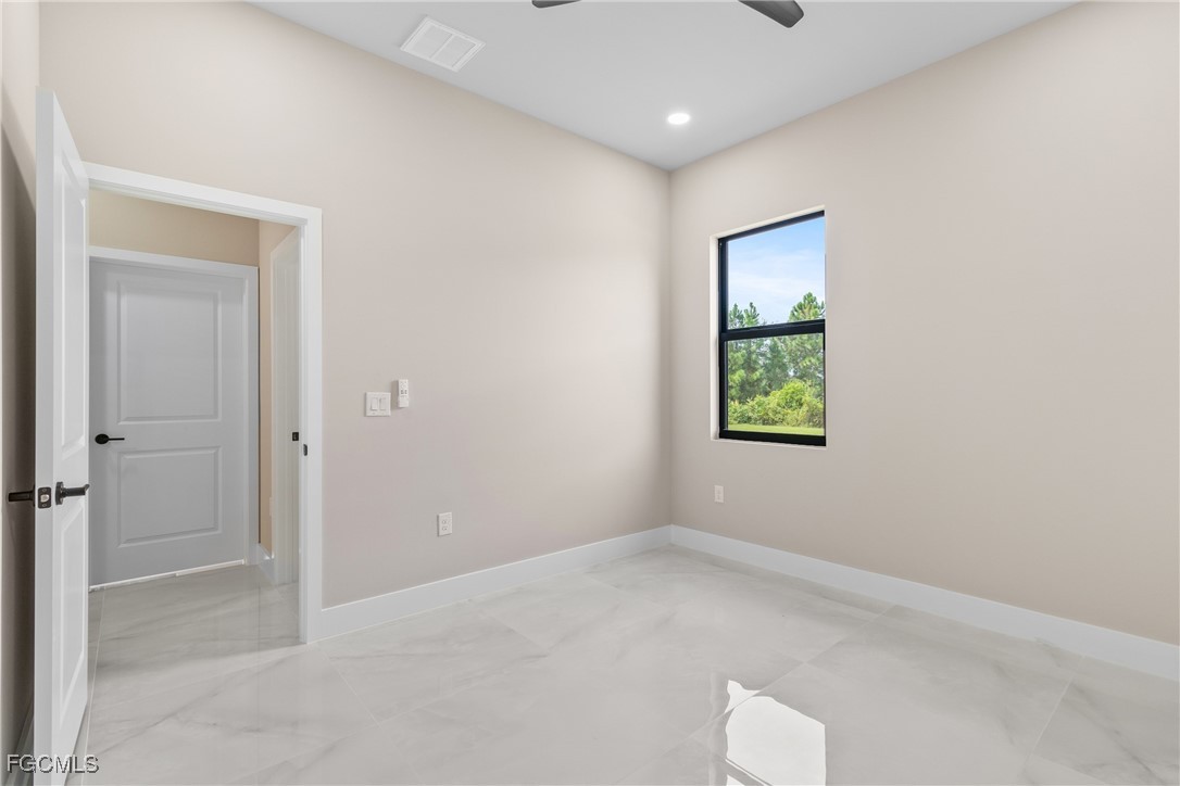 2809 25th Street Southwest Lehigh Acres, FL 33976 - Photo 21 of 36 an empty room with windows and closet