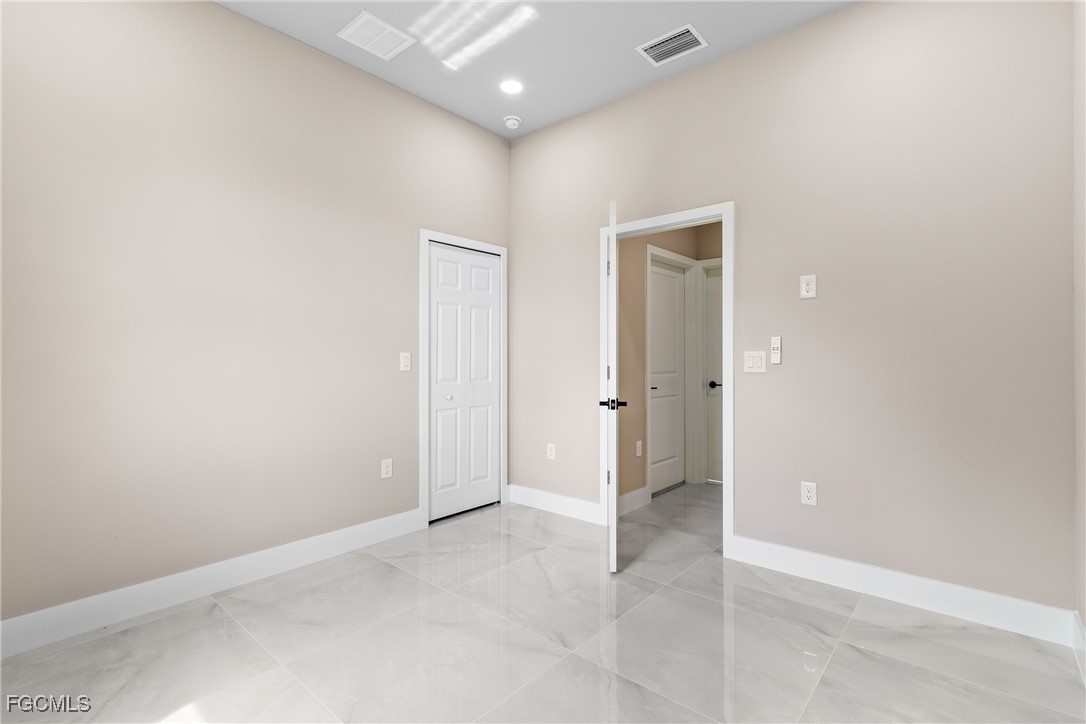 2809 25th Street Southwest Lehigh Acres, FL 33976 - Photo 25 of 36 an empty room with closet and a hallway