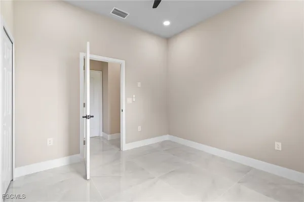 an empty room with windows and outdoor view