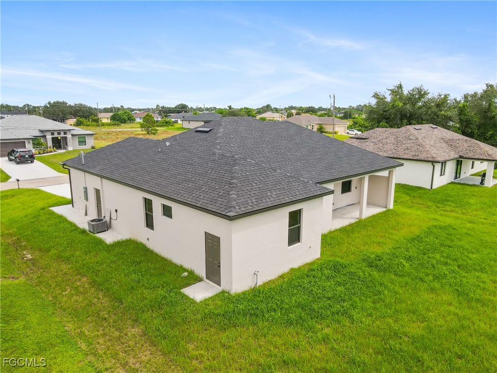 2809 25th Street Southwest Lehigh Acres, FL 33976 - Photo 32 of 36 a aerial view of a house with a yard