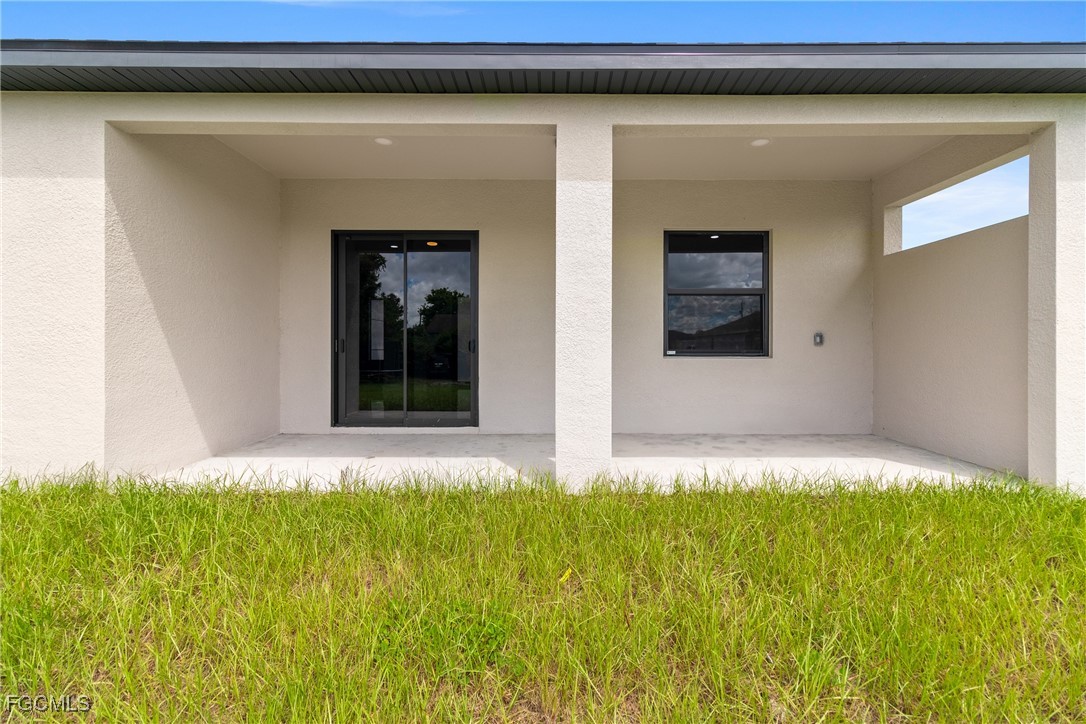 2809 25th Street Southwest Lehigh Acres, FL 33976 - Photo 34 of 36 a white house with a large window and front door