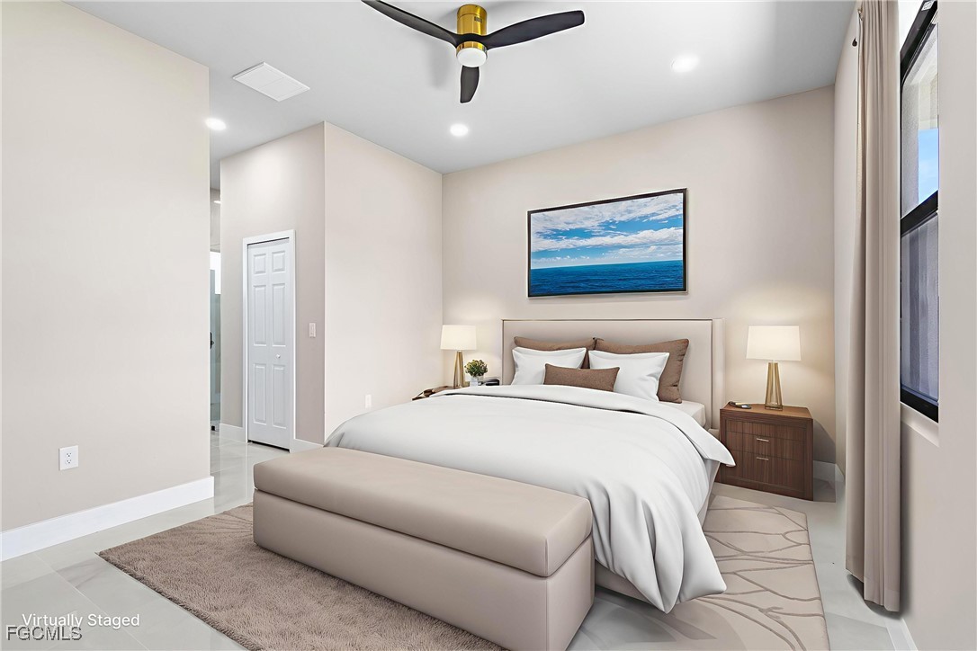 2809 25th Street Southwest Lehigh Acres, FL 33976 - Photo 4 of 36 a bedroom with a bed and a painting on the wall