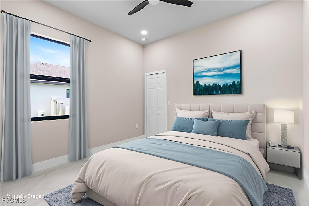 2809 25th Street Southwest Lehigh Acres, FL 33976 - Photo 5 of 36 a bedroom with a bed and a painting on the wall