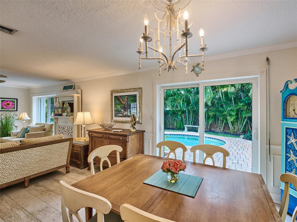 3220 Oleander Way Lauderdale-by-the-Sea, FL 33062 - Photo 13 of 50 a living room with fireplace furniture and a chandelier