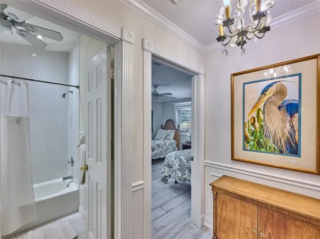 a bathroom with a painting on the wall and a shower
