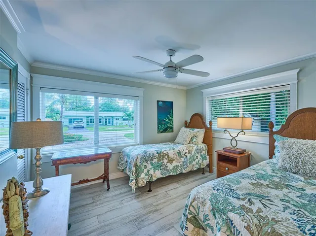 a bedroom with two beds and a chandelier