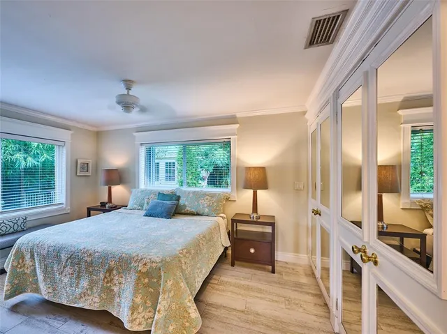 a bedroom with a large bed and a large window