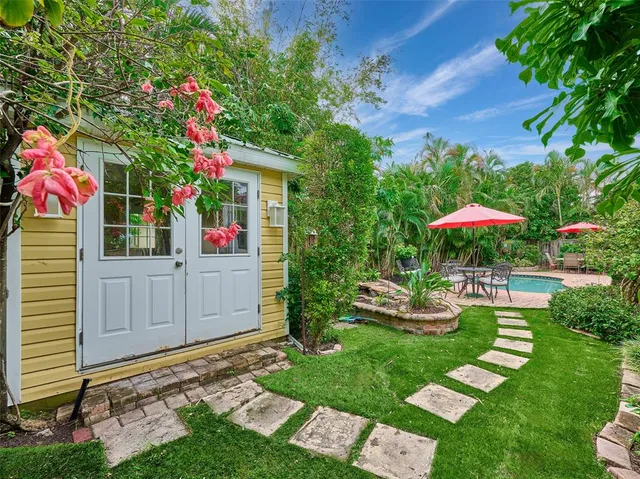 a backyard of a house with table and chairs