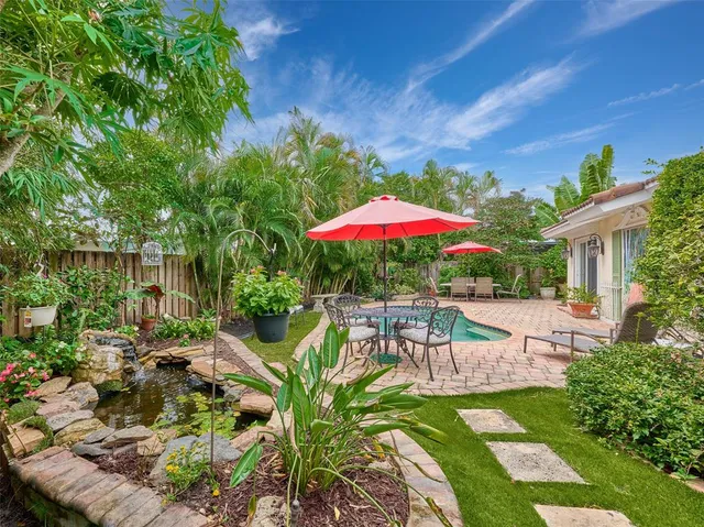 a view of a house with backyard sitting area and garden