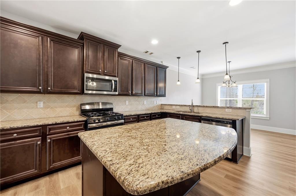 268 Clubhouse Crossing Acworth, GA 30101 - Photo 17 of 48 a kitchen with a stove a sink and a microwave