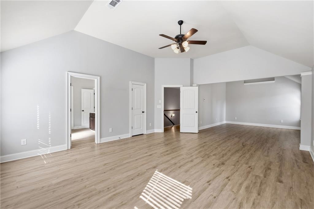 268 Clubhouse Crossing Acworth, GA 30101 - Photo 30 of 48 a view of empty room with wooden floor and ceiling fan