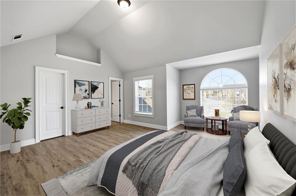 268 Clubhouse Crossing Acworth, GA 30101 - Photo 39 of 48 a spacious bedroom with a bed a couch and a large window