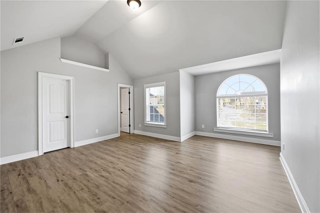 268 Clubhouse Crossing Acworth, GA 30101 - Photo 40 of 48 a view of an empty room with wooden floor and a window