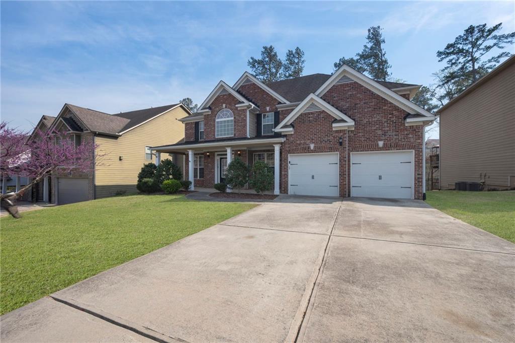 268 Clubhouse Crossing Acworth, GA 30101 - Photo 6 of 48 a view of a big house with a big yard and large tree