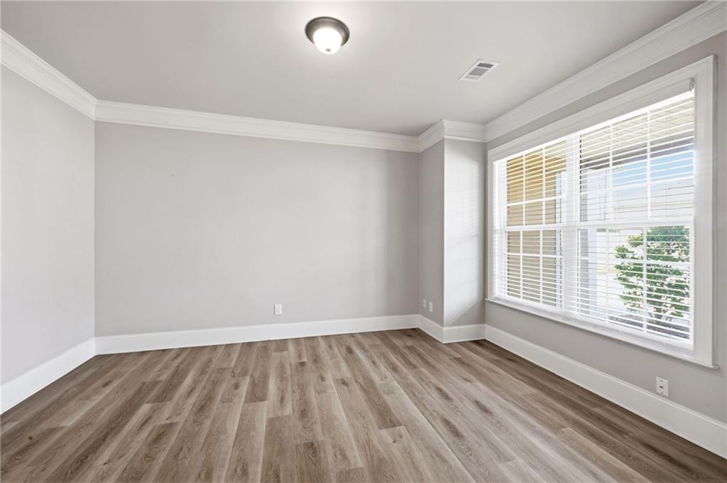 268 Clubhouse Crossing Acworth, GA 30101 - Photo 9 of 48 a view of an empty room with wooden floor and a window