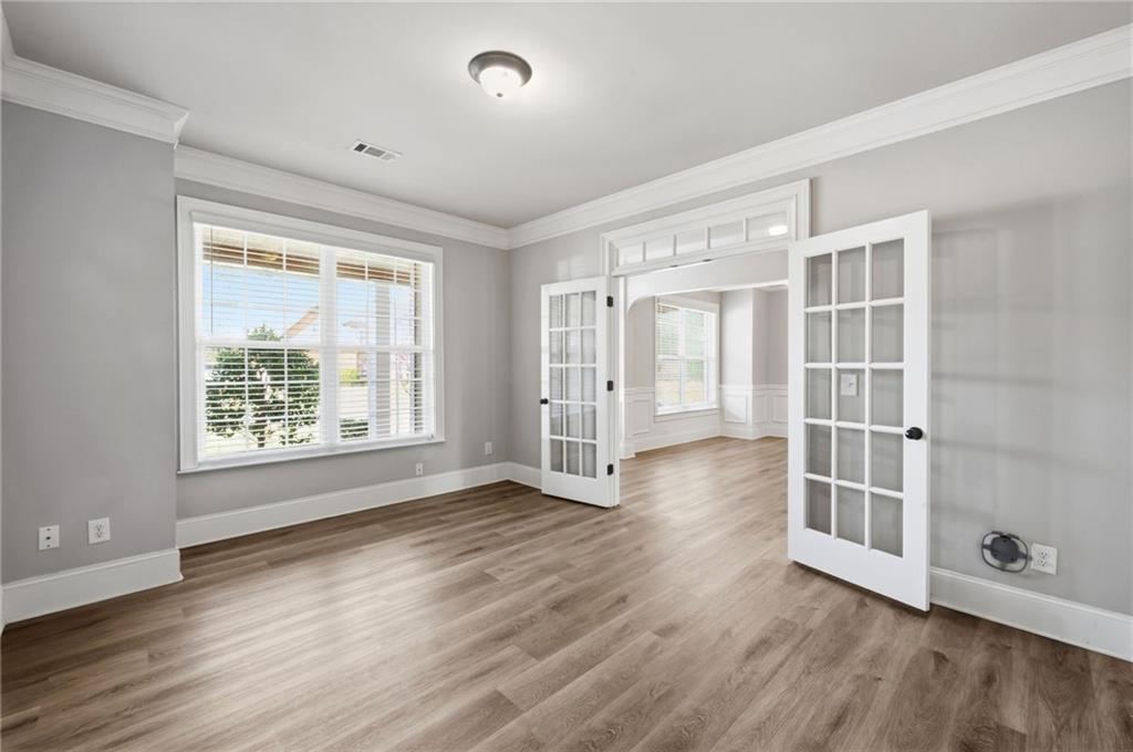 268 Clubhouse Crossing Acworth, GA 30101 - Photo 10 of 48 an empty room with wooden floor and windows