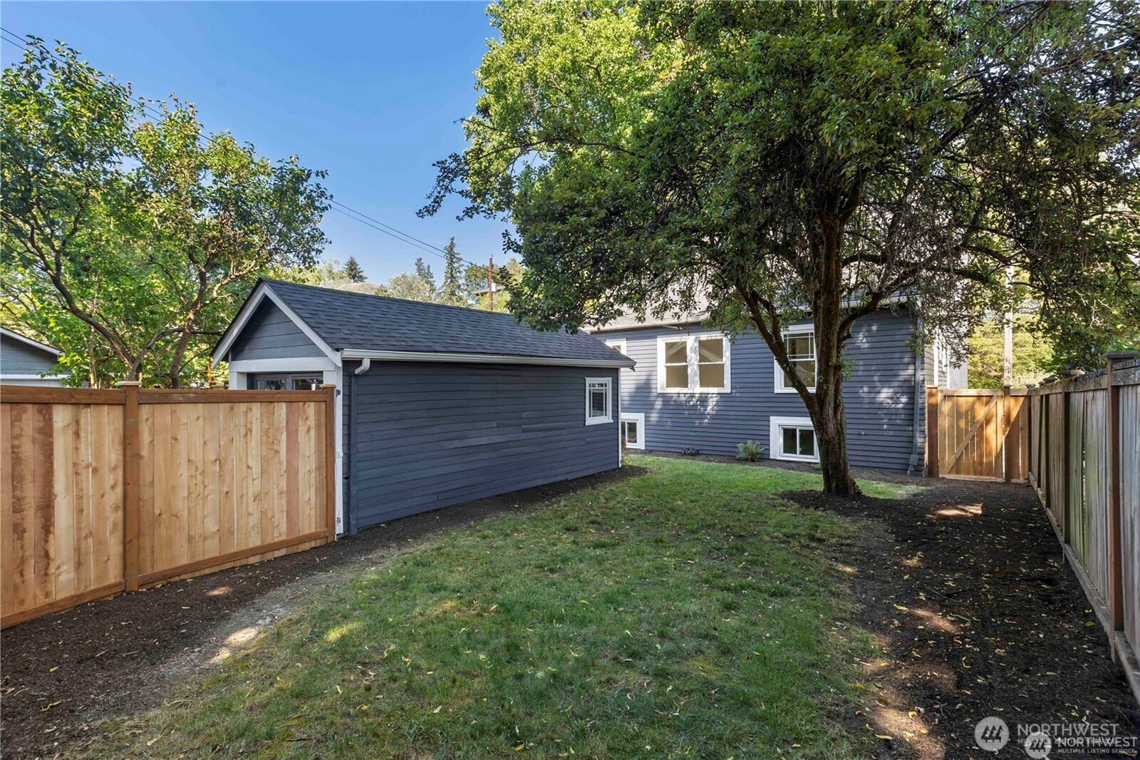 3221 36th Avenue South Seattle, WA 98144 - Photo 12 of 13 a view of a backyard with barn and large trees