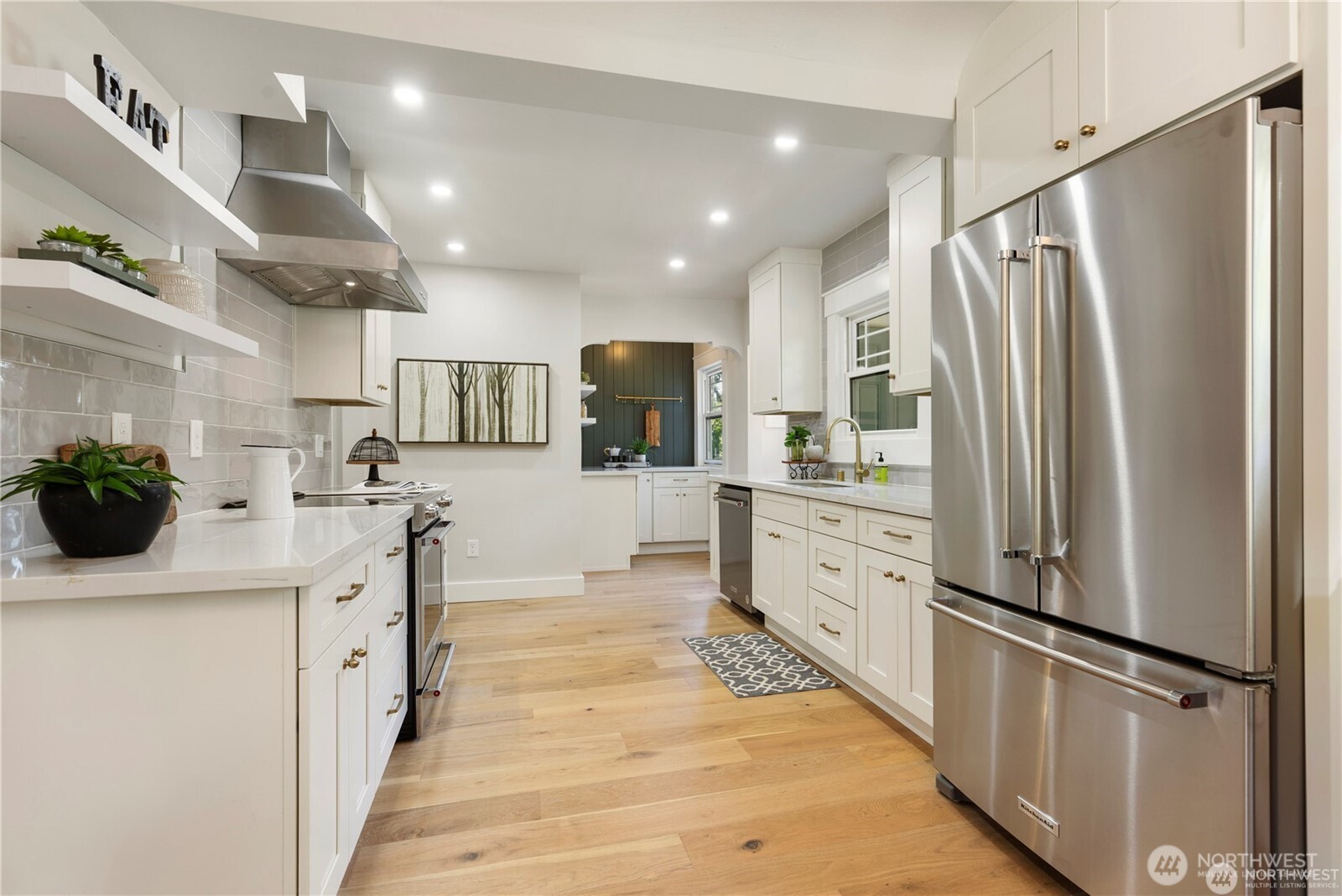 3221 36th Avenue South Seattle, WA 98144 - Photo 4 of 13 a kitchen with stainless steel appliances a refrigerator sink and microwave