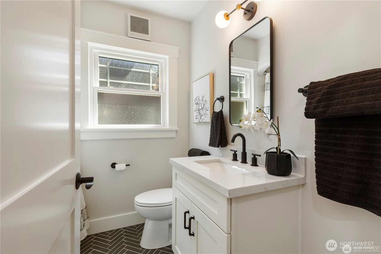3221 36th Avenue South Seattle, WA 98144 - Photo 7 of 13 a bathroom with a sink toilet and mirror