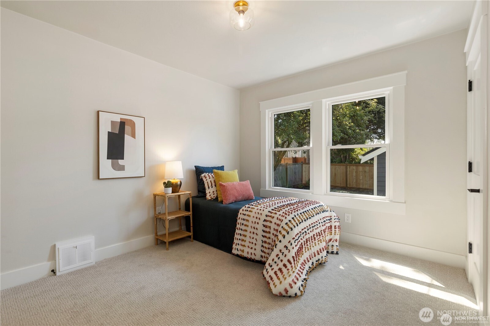 3221 36th Avenue South Seattle, WA 98144 - Photo 9 of 13 a bedroom with a bed lamp and a window