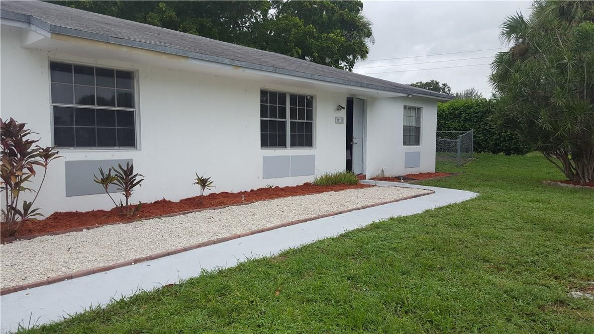 19258 Liberty Road Boca Raton, FL 33434 - Photo 1 of 11 a front view of a house with garden