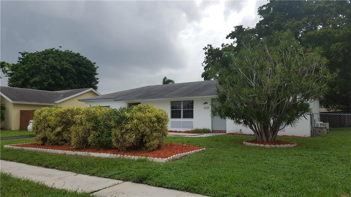 19258 Liberty Road Boca Raton, FL 33434 - Photo 2 of 11 a front view of a house with a garden