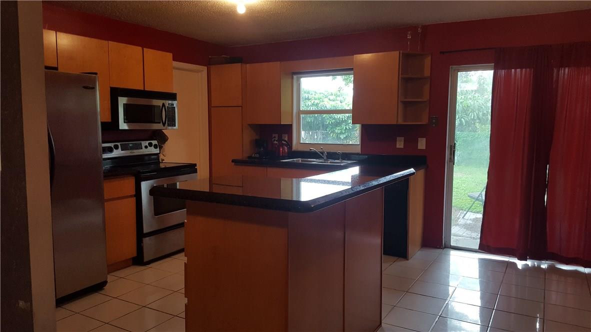 19258 Liberty Road Boca Raton, FL 33434 - Photo 3 of 11 a kitchen with stainless steel appliances granite countertop a refrigerator and a sink