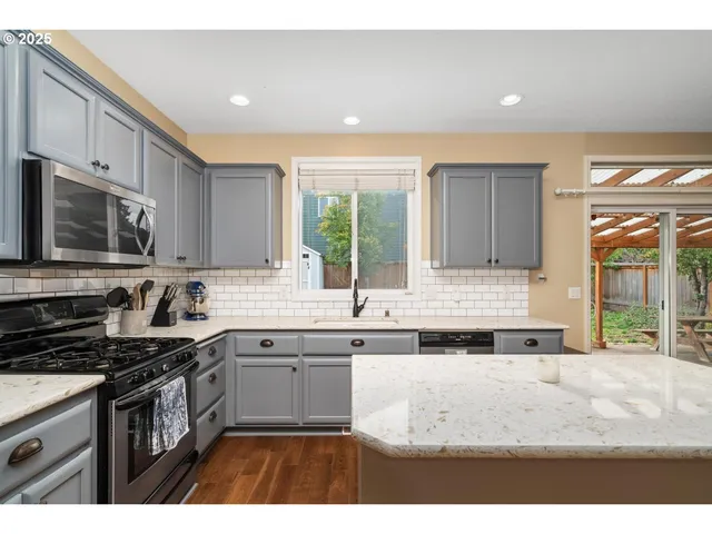 a kitchen with a sink stove top oven and microwave