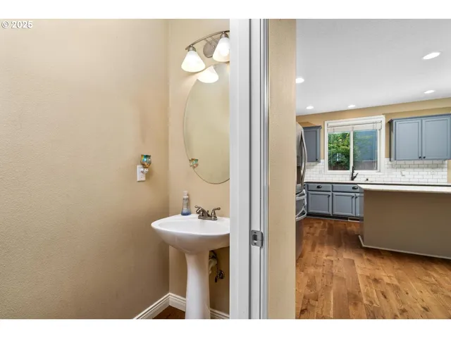 a bathroom with a sink mirror and toilet