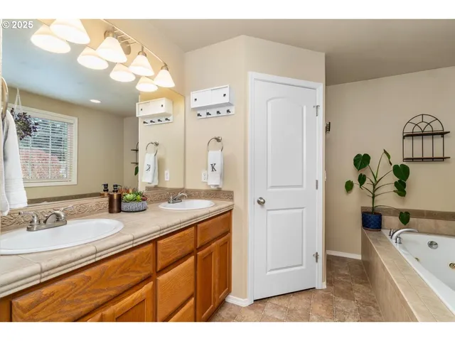 a bathroom with a tub a sink and a mirror