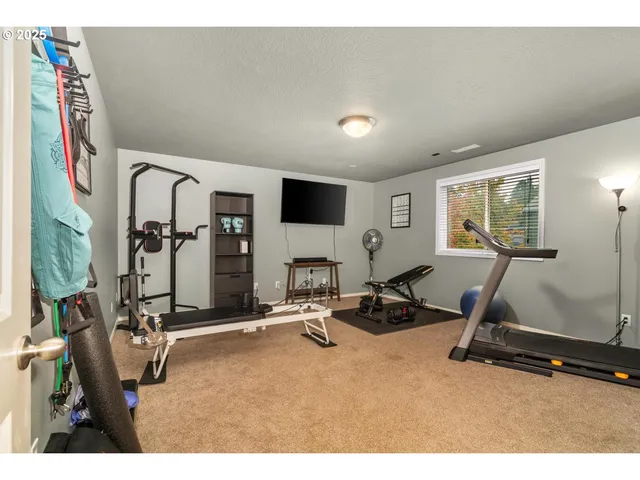a room with gym equipment and large mirror
