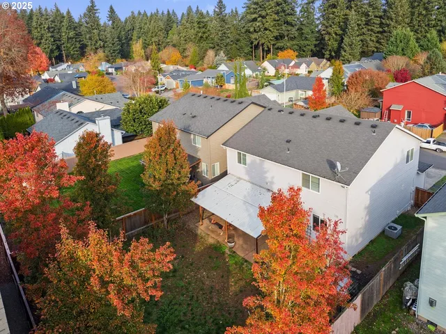an aerial view of a house with a swimming pool