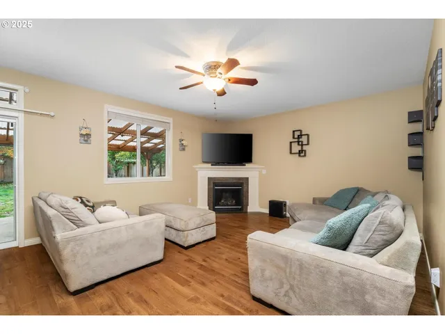 a living room with furniture a fireplace and a flat screen tv
