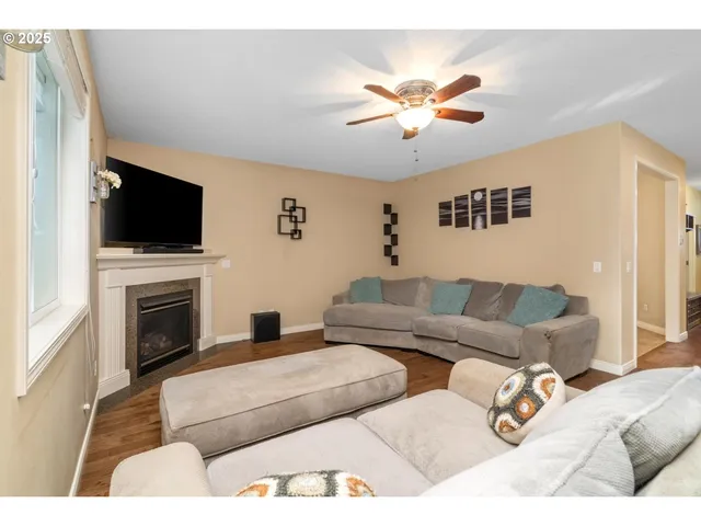 a living room with furniture a fireplace and a flat screen tv