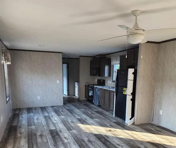 a view of a kitchen with wooden floor and electronic appliances