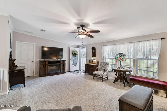 a view of a livingroom with furniture and an entryway