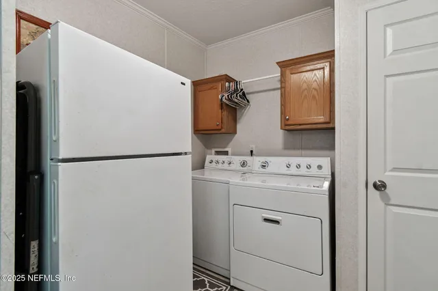 a room with stainless steel appliances furniture a rug and a window