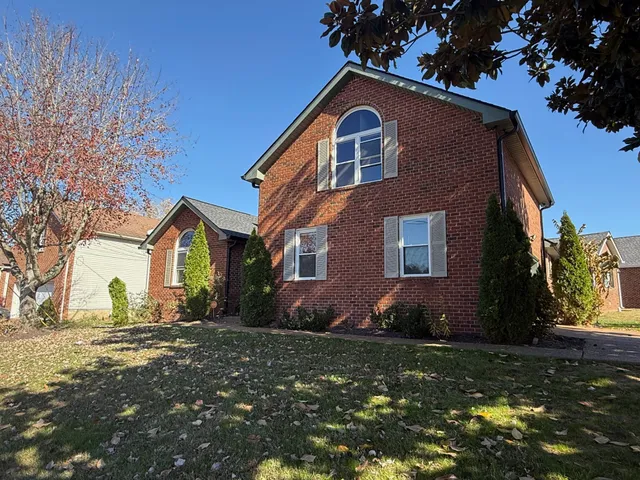 a front view of a house with a yard