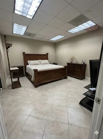 a bedroom with a bed and flat screen tv