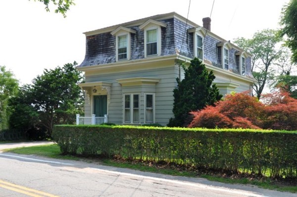 a view of a brick building next to a yard