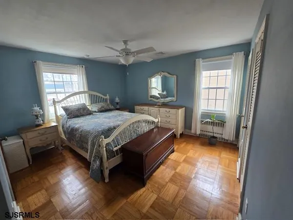 a bedroom with a bed chandelier and a window