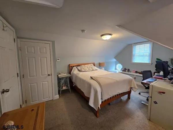 a bedroom with a bed and a table in it