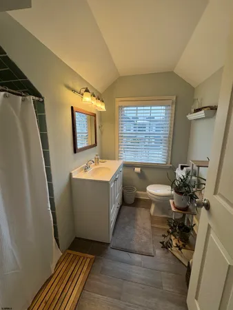 a bathroom with a sink mirror toilet and bathtub