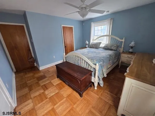 a bedroom with a bed window and a rug