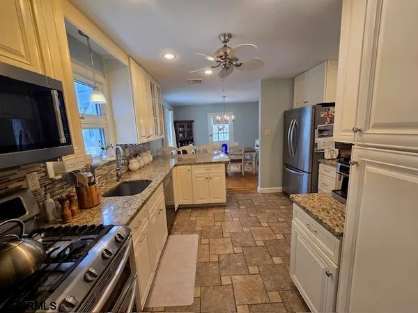 a kitchen with a sink appliances and cabinets