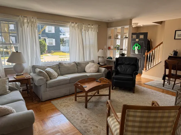 a living room with furniture and wooden floor